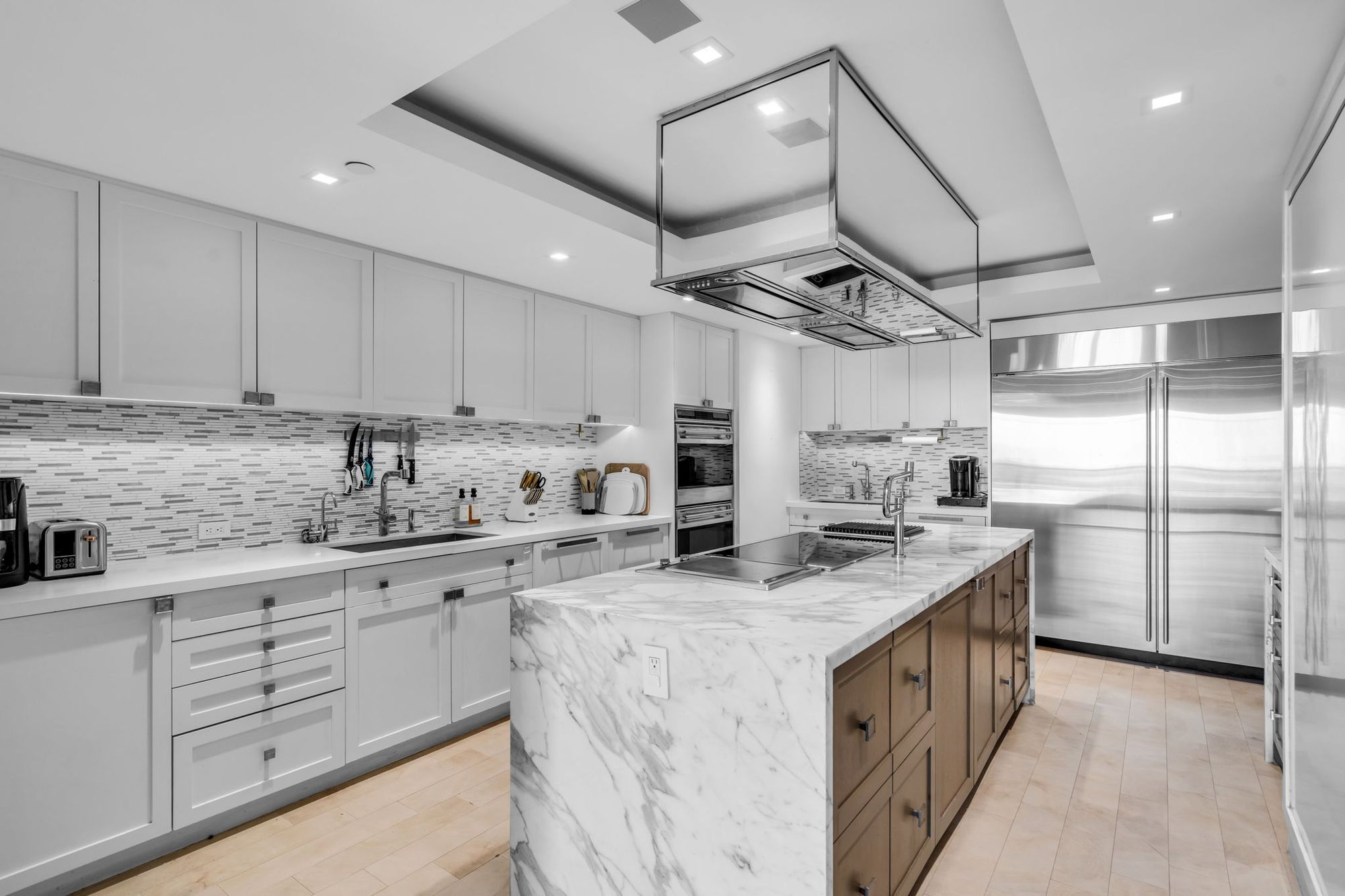 Marble kitchen island with custom cabinetry
