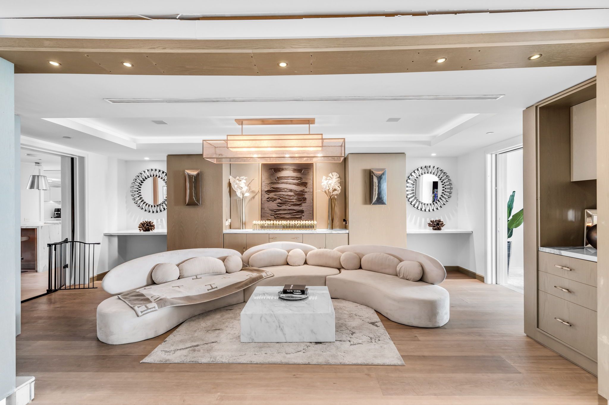 The grand salon with sculptural seating beneath coffered oak ceilings